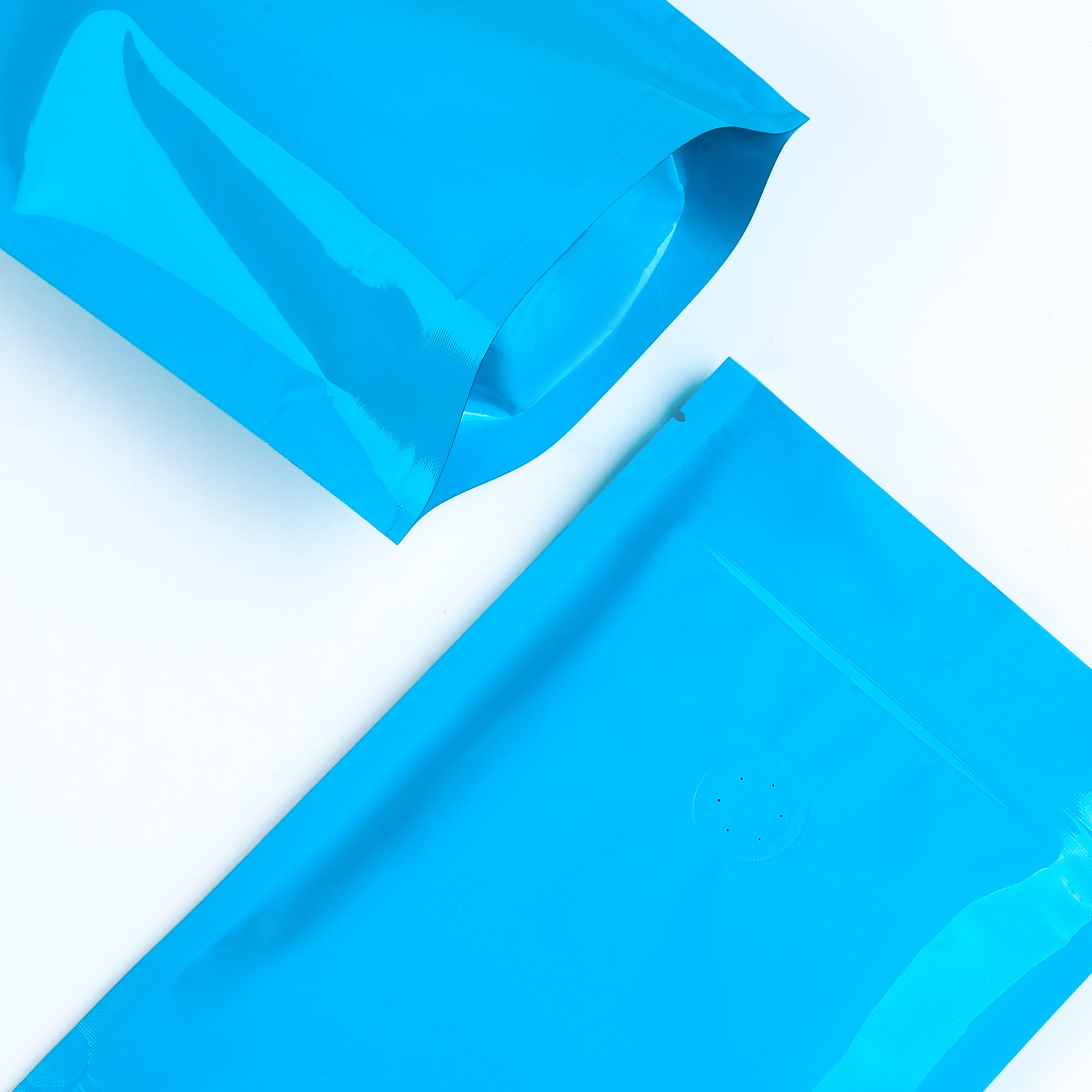 Glossy Full Bodied Wavy Blue Round Window Plastic and Mylar Stand Strong® Coffee Valve Bags